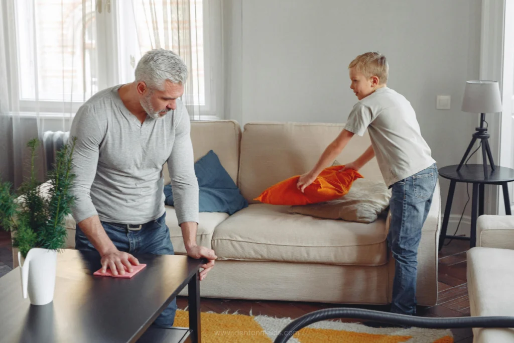 Dad and his kid cleaning living room - Denton Maids