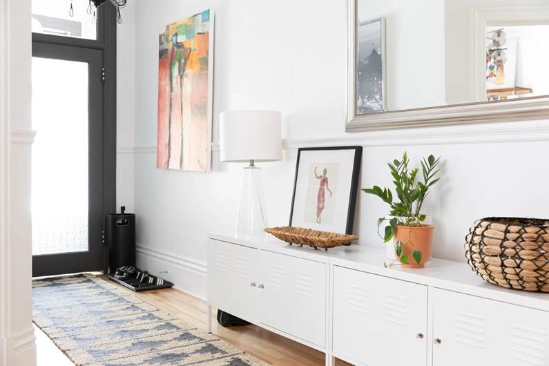 Bright entryway with runner rug and console storage kept tidy.